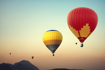 Fototapeta na wymiar Hot air balloon over mountain on sky sunset , vintage and retro filter effect style