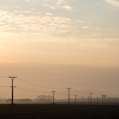 Fototapeta na wymiar sunset over the fields in fog