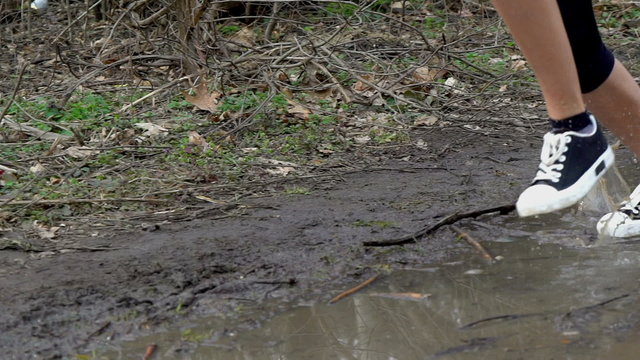Runner woman jogging  through puddles. Running in any weather.