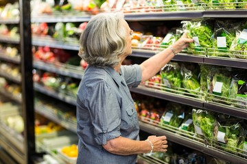 Senior woman picking out some vegetables