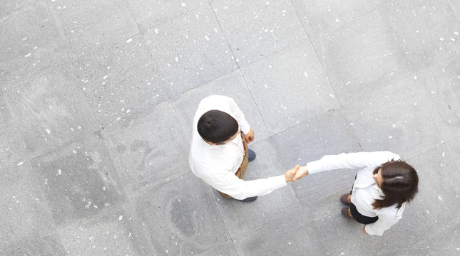 Top View Of Business Partners Shaking Hands