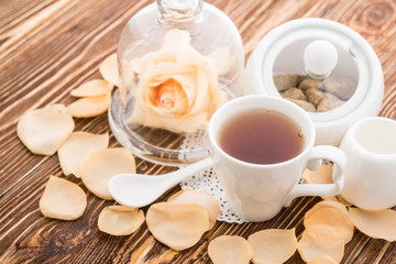 Tea cups with teapot on old wooden table