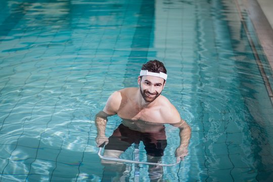 Smiling man doing underwater bike