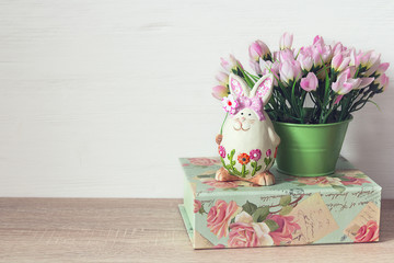 Pink snowdrops in a pot, the Easter bunny in an egg shape for th