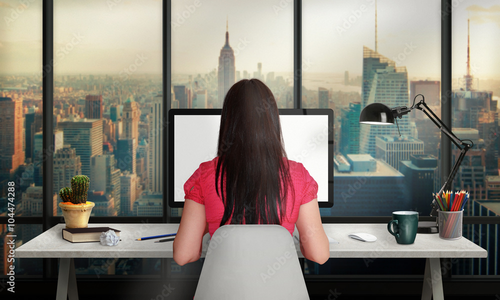 Poster woman work on office computer with isolated screen for mockup. office with a view of the skyscrapers