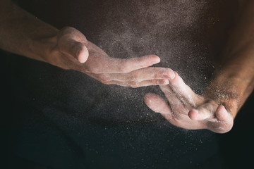 Obraz na płótnie Canvas adult man hands working with flour closeup, vintage toned photo