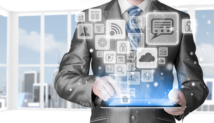 Business man using tablet PC with social media icon set