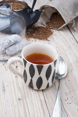 Cup of healthy traditional herbal rooibos red beverage tea with
