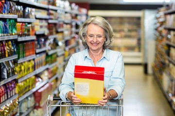 Smiling senior woman buying cereals