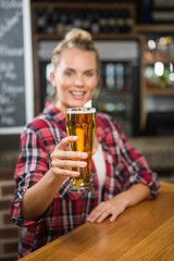 Pretty smiling woman having a beer