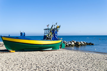 Naklejka na ściany i meble Fishing boat on the coast at Gdynia Orlowo at Baltic sea, Poland.