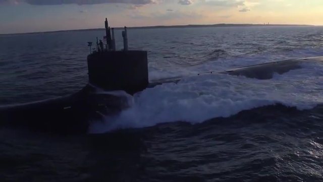 Excellent aerials over a submarine at sea.