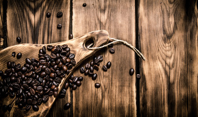 Fresh aromatic coffee beans on a wooden Board.