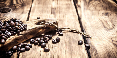 Fresh aromatic coffee beans on a wooden Board.
