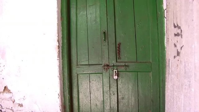 Up close view of green door and latch