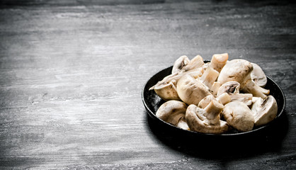 Fresh sliced mushrooms in the pan.