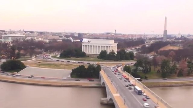U.S. Customs and Border Protection helicopter flies against the U.S. capital skyline.