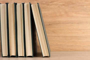 Stack of books on wooden background