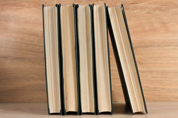Stack of books on wooden background