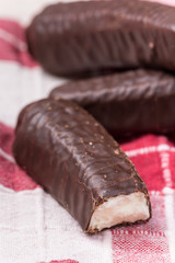 Bunch of chocolate bananas on the kitchen tablecloth