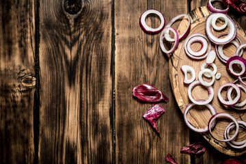 Onion rings with seeds on a wooden Board.