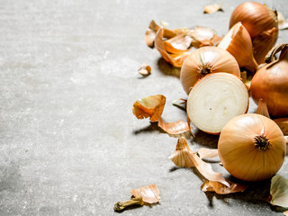 Fresh onion on stone background.
