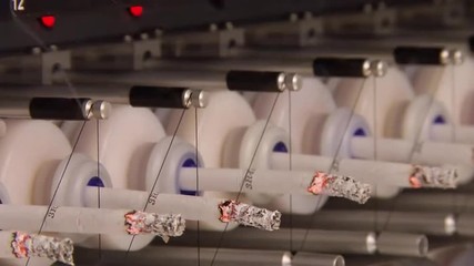 Scientists at the CDC Center For Disease Control use laboratory equipment and an artificial smoking machine to collect and analyze the particulate matter and chemicals found in tobacco products.