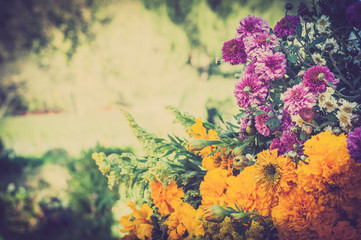 Obraz na płótnie Canvas Bunch of flowers on a blurry garden background, vintage photo.