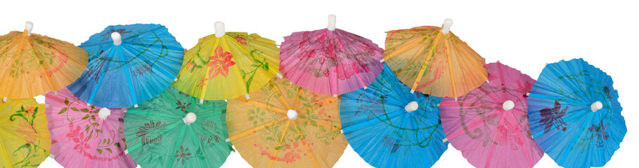 Colorful paper cocktail umbrella close-up on a white