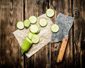 Sliced zucchini and an old hatchet .