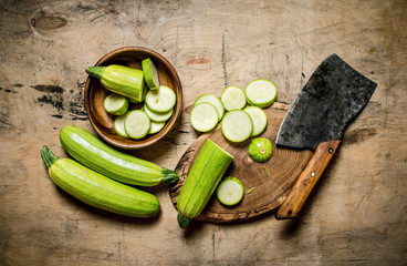 Sliced zucchini and an old hatchet .
