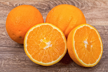 The orange oranges on a wooden background