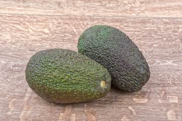 Two of avocado on a wooden background