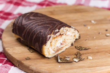 Sliced chocolate roll cake on the wooden board