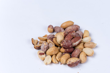 Bunch of roasted peanuts on the white background