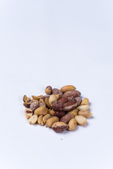 Bunch of roasted peanuts on the white background