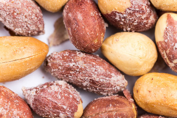 Top macro view of roasted pile of peanuts