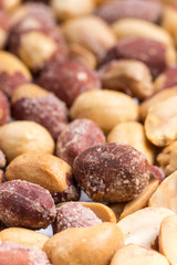 Top macro view of roasted pile of peanuts