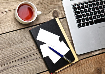 on vintage table tea,laptop and business cards