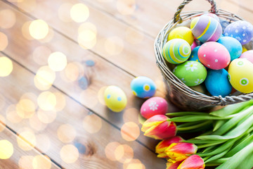 Fototapeta na wymiar close up of easter eggs in basket and flowers