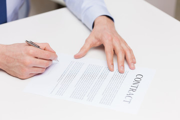 Fototapeta na wymiar close up of male hands signing contract document
