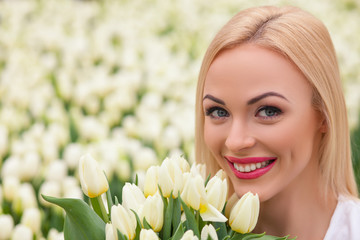 Cheerful young florist with white tulips