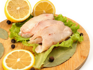 Pieces of sea bass on a cutting board.