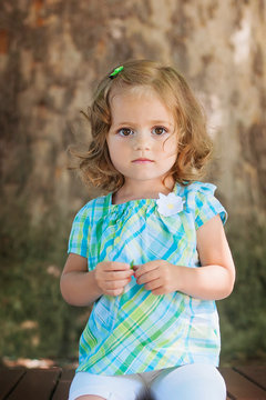 cute fashion little firl posing outdoor