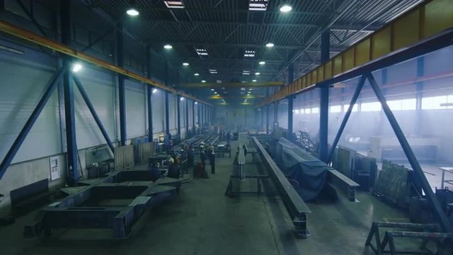 Timelapse footage of a heavy industry factory with workers and flying sparks. Shot on RED Cinema Camera.