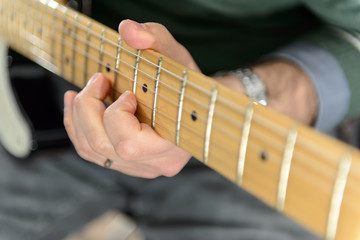 Electric Guitar / Detail of an electric guitar. Hands moving on the keyboard. Close up. 