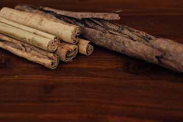 Bunch of cinnamon sticks on wooden table