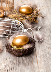 Fototapeta na wymiar golden egg of chickens in nest, on wooden background