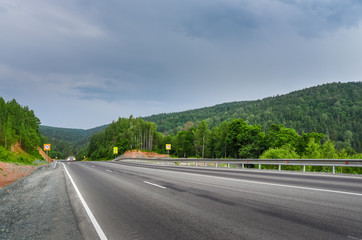 Dangerous bend in the mountains. The descent from the pass