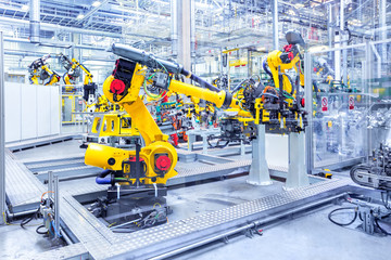robotic arms in a car plant - obrazy, fototapety, plakaty